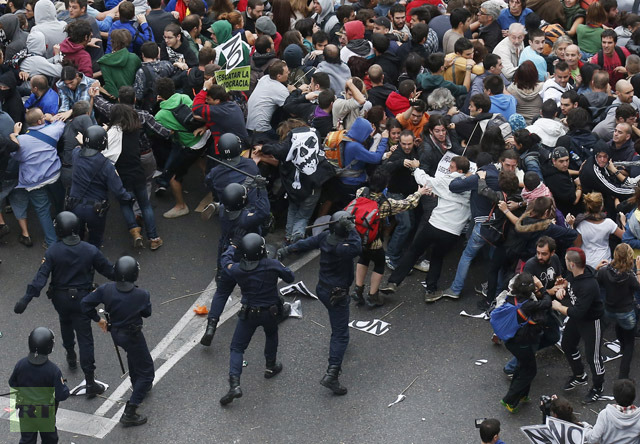 Riot police clash with protesters close to Spain's Parliament during a demostration in Madrid