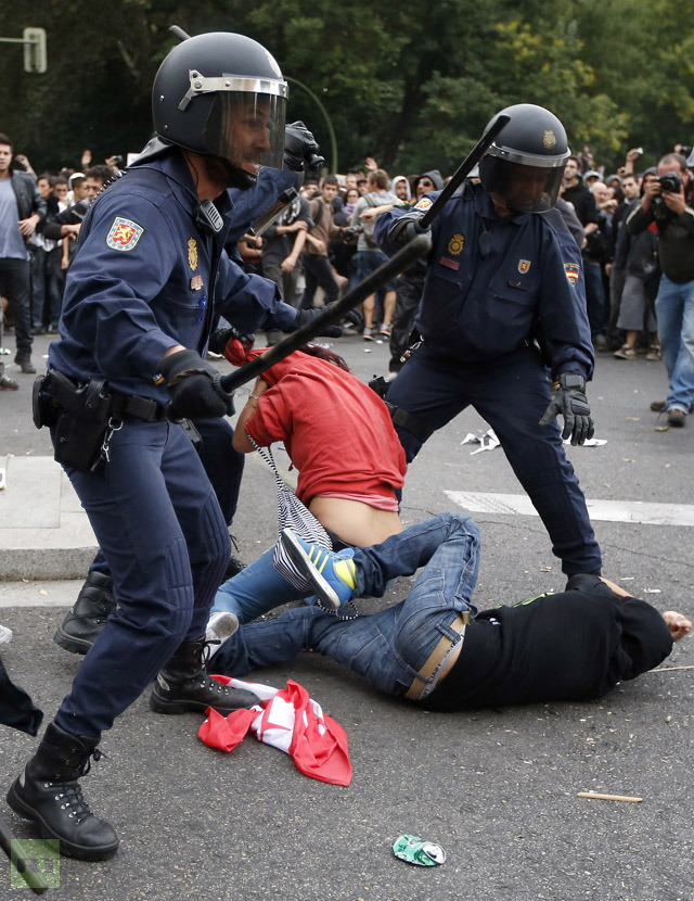 Police charge at demonstrators outside the the Spanish parliament in Madrid