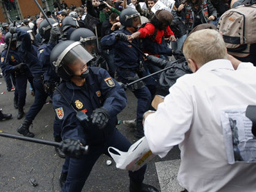 Police charge demonstrators outside the the Spanish parliament in Madrid