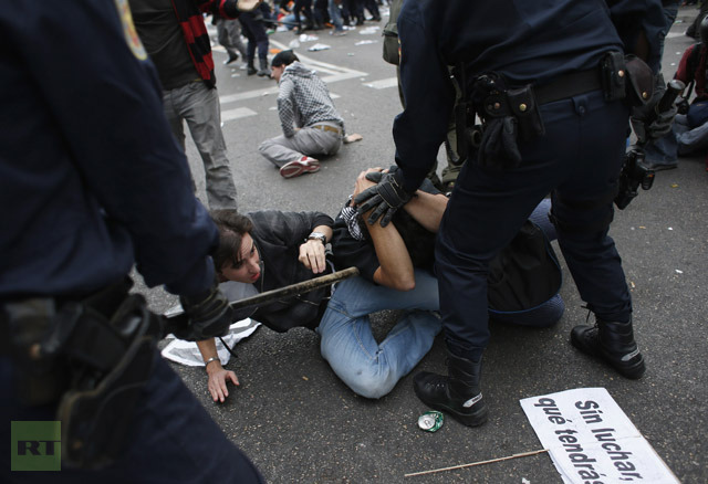 Spanish riot police push demonstrators onto floor outside parliament in Madrid